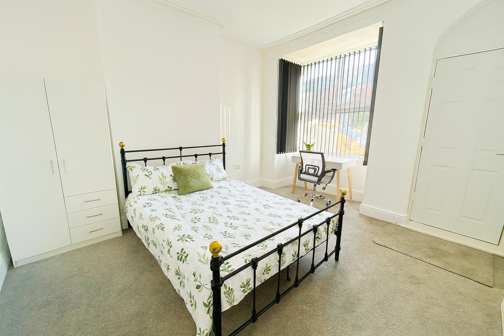 Bright and inviting bedroom featuring a stylish...