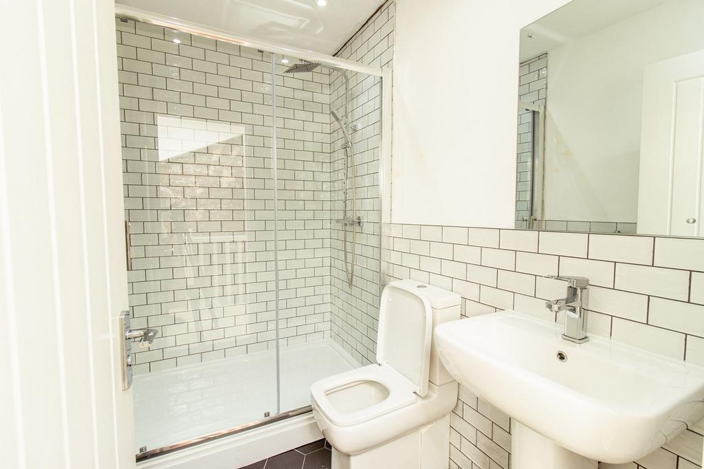Modern bathroom featuring a spacious shower wit...