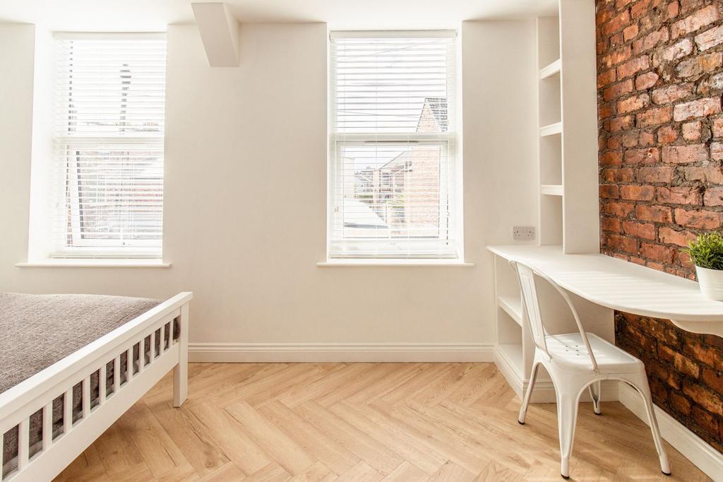 Bright and inviting bedroom with ample natural ...