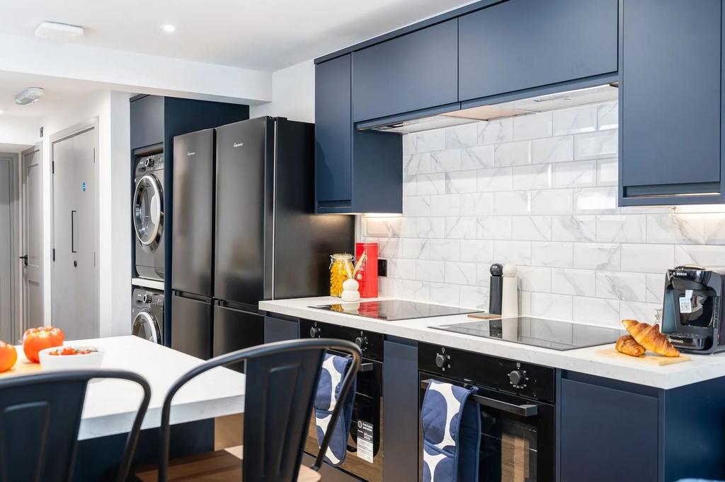 Modern and stylish kitchen featuring sleek blue...