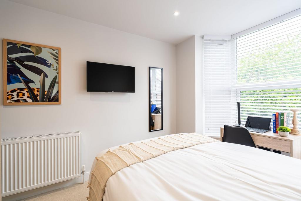 Bright and inviting bedroom featuring a comfort...