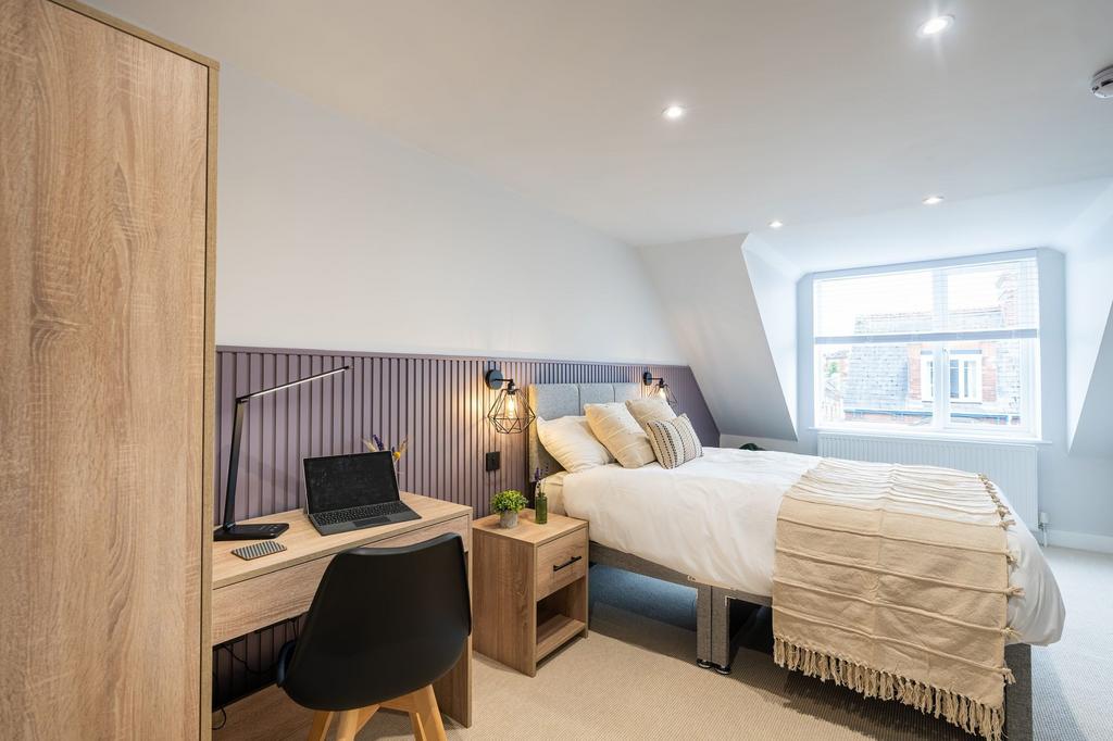 Bright and modern, this spacious master bedroom...