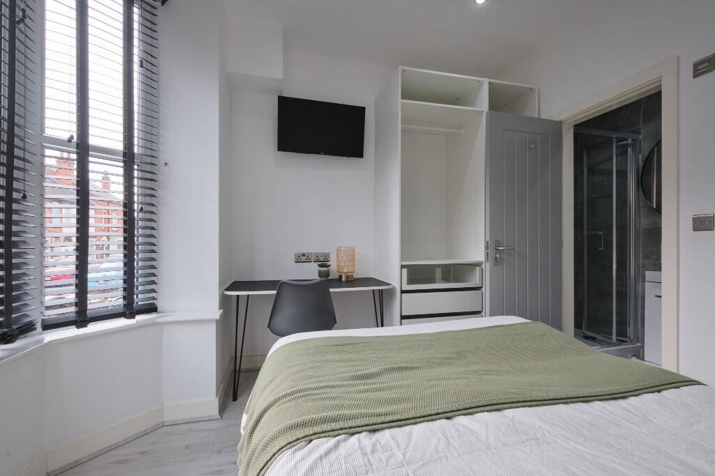 Bright and welcoming bedroom featuring a comfor...