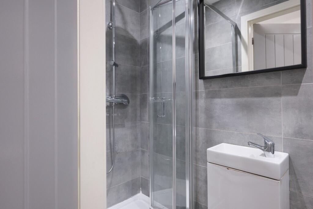A modern and clean bathroom suite featuring a s...