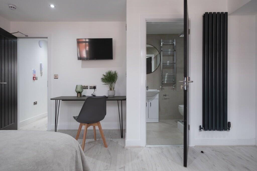 A modern master bedroom featuring a comfortable...