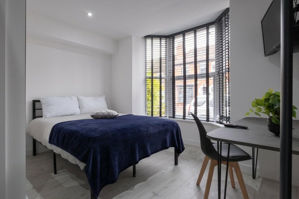 Bright and modern double bedroom featuring a co...