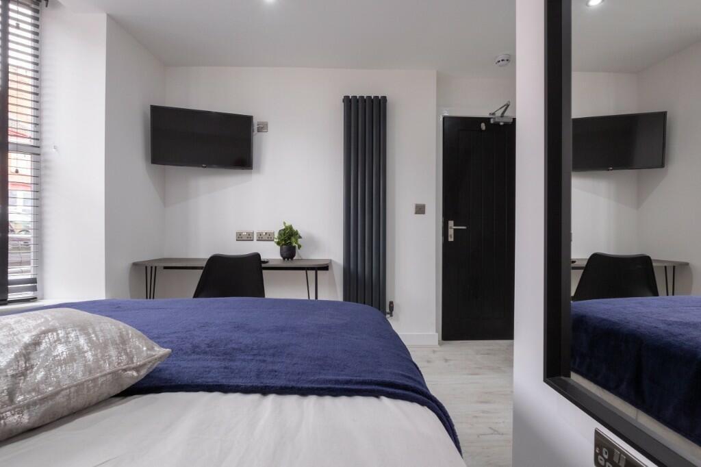 A modern double bedroom featuring a comfortable...