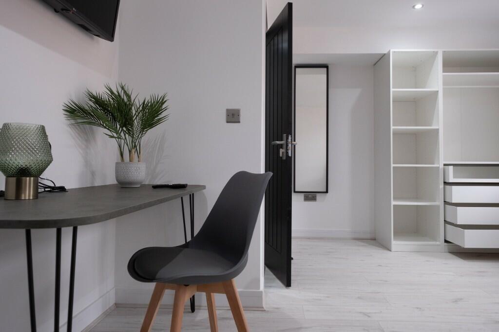 A modern double bedroom featuring a sleek black...