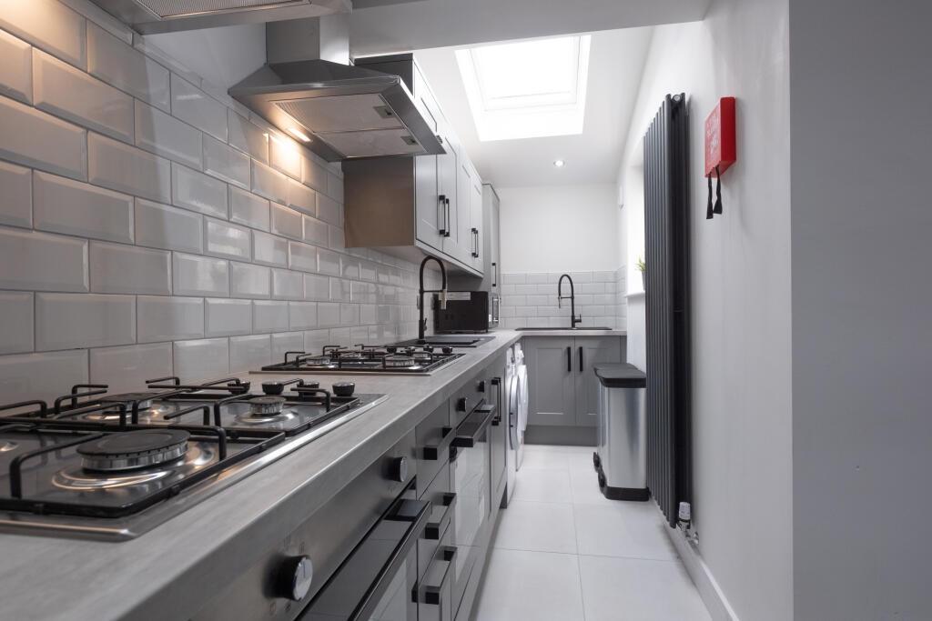 Modern and bright kitchen with sleek countertop...
