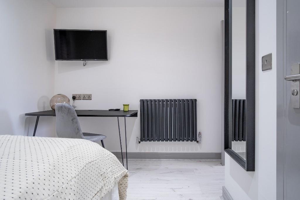 A modern and spacious master bedroom featuring ...