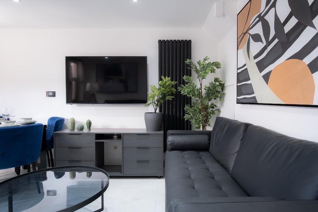 A modern, stylish living room featuring a large...