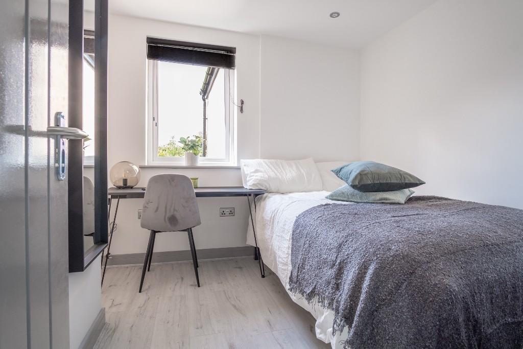 A cozy and well-maintained bedroom featuring a ...