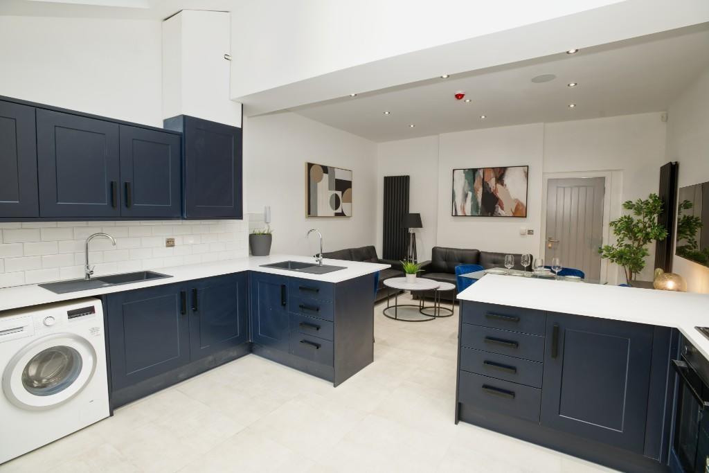 Modern kitchen with stylish dark blue cabinetry...