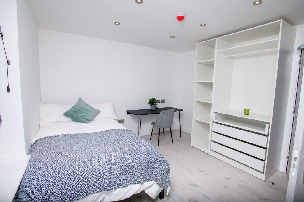 A bright and spacious master bedroom featuring ...