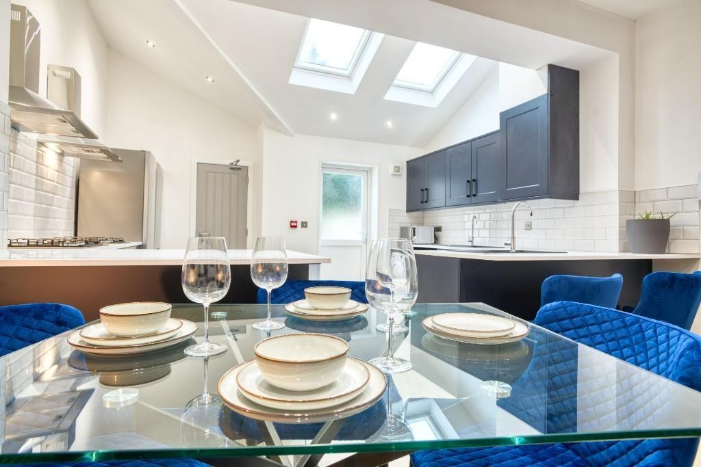 A modern, bright kitchen area with ample natura...