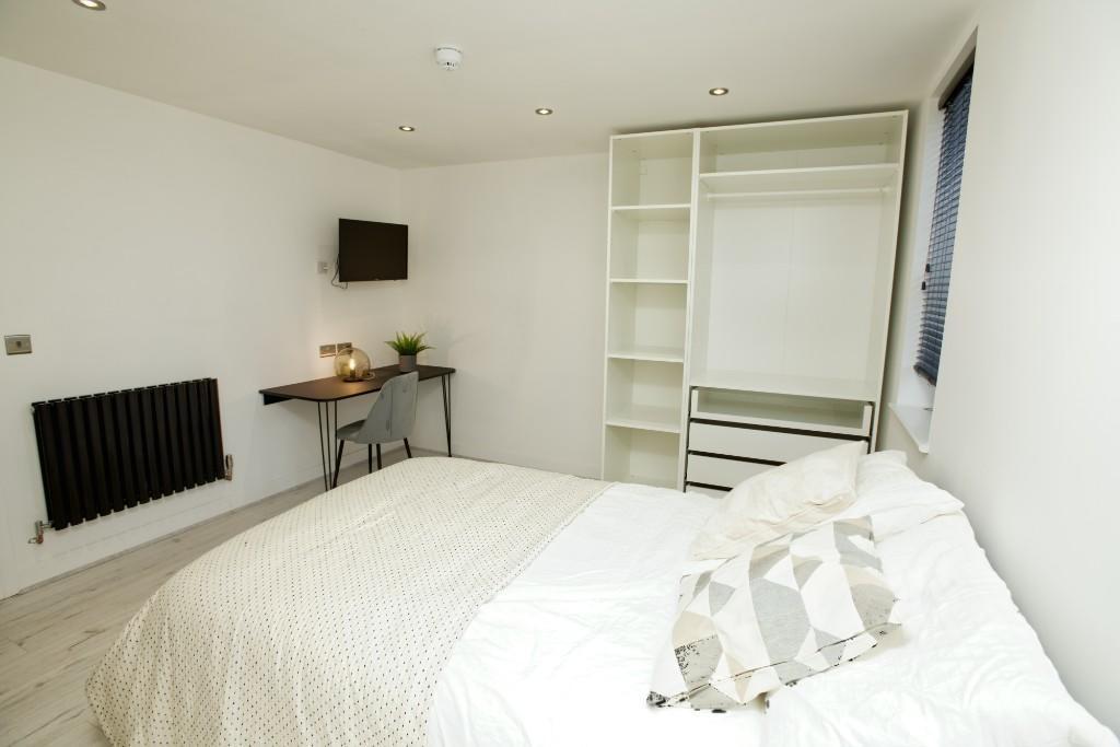 A bright and spacious master bedroom featuring ...