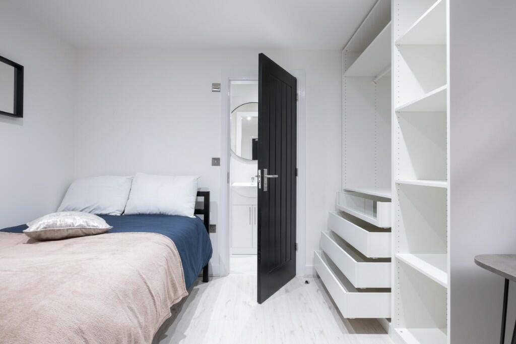 A bright and modern master bedroom featuring a ...