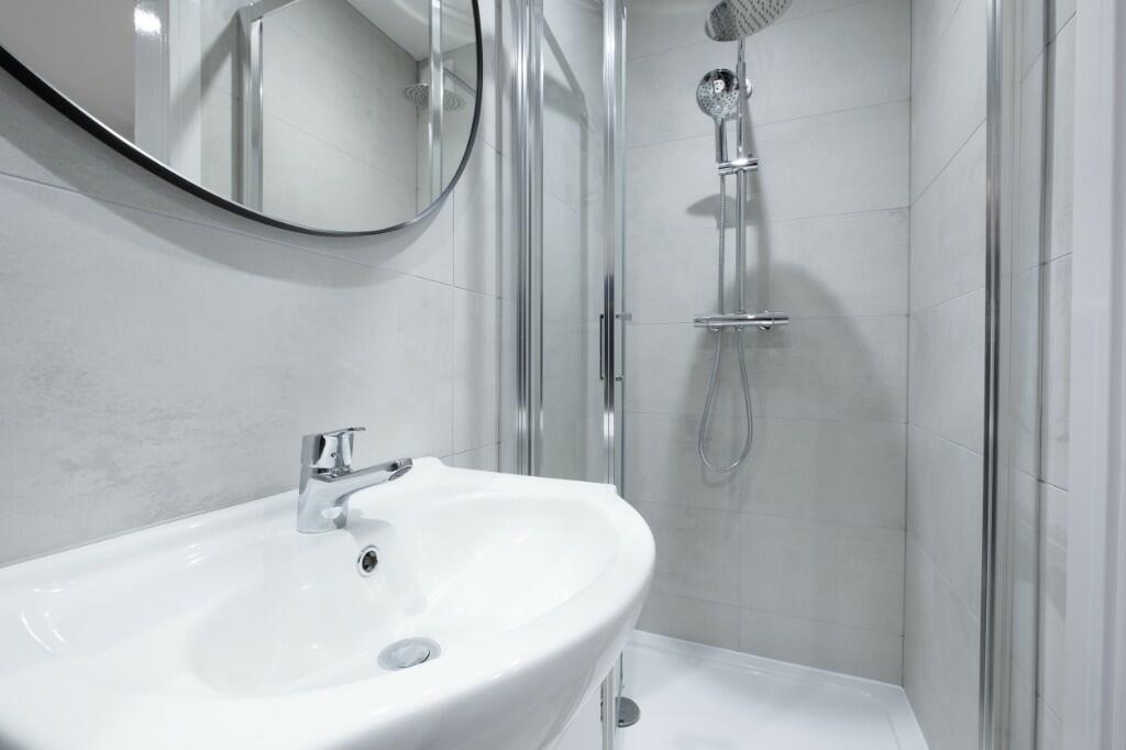 A clean and modern bathroom featuring a spaciou...