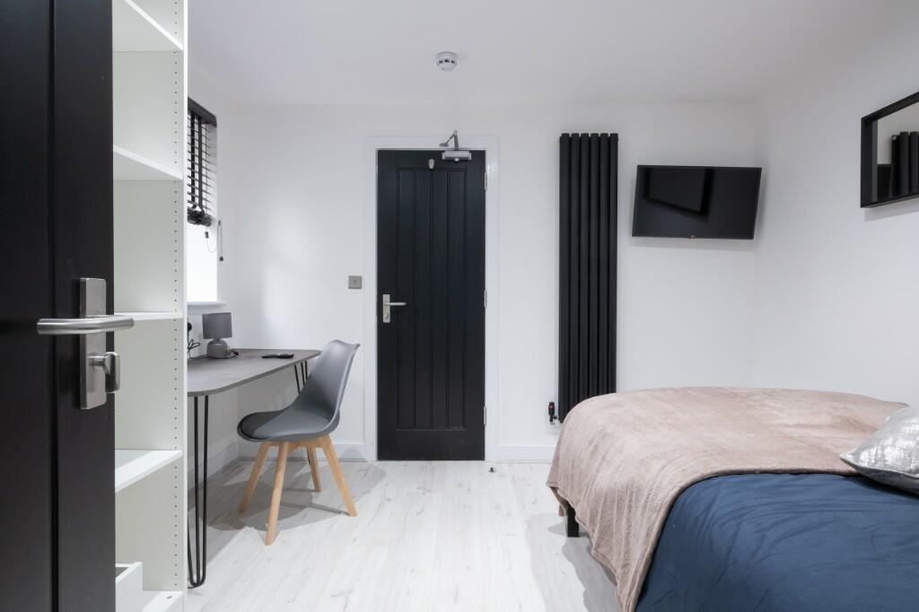 A modern, well-maintained bedroom featuring a n...