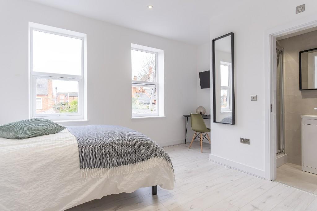 A bright and spacious master bedroom featuring ...