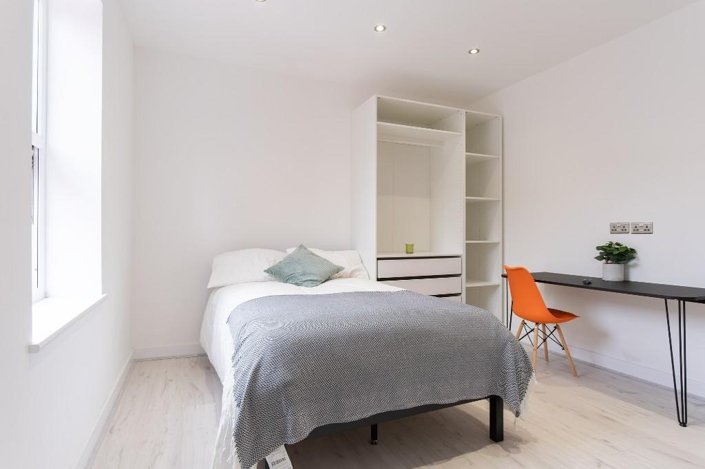 A bright and inviting double bedroom featuring ...