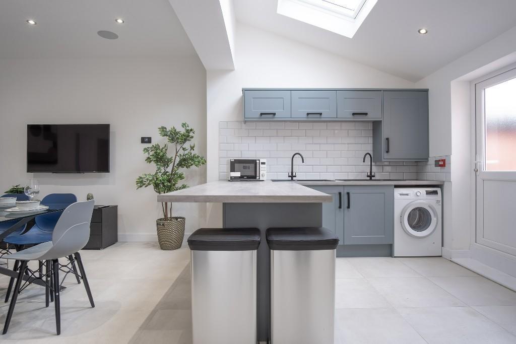 Modern and bright kitchen area featuring stylis...