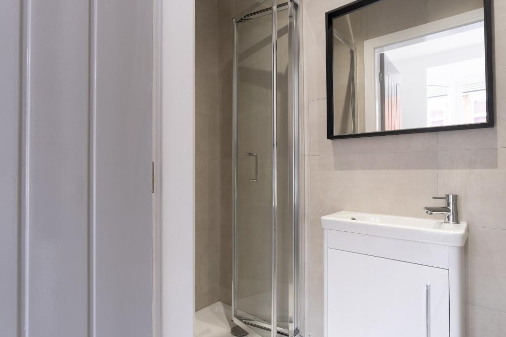 A clean and well-maintained bathroom with a gla...