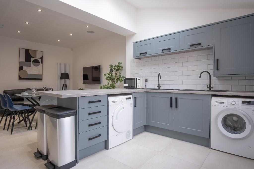 Bright and modern kitchen with ample counter sp...