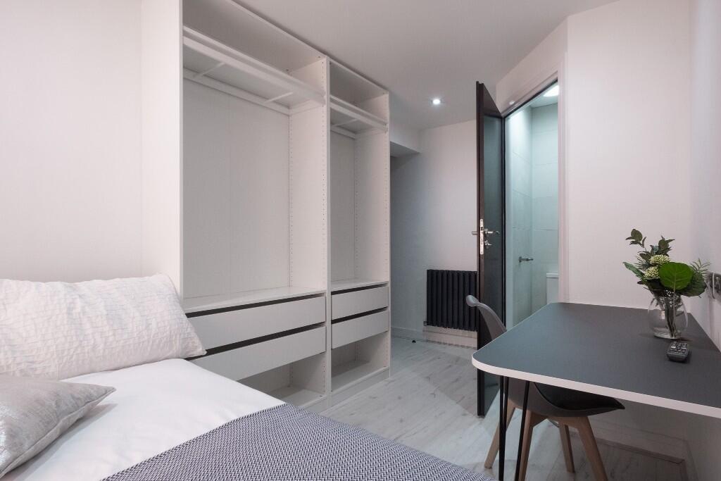 A modern, well-maintained bedroom featuring a c...