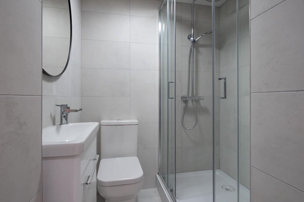 A clean and modern bathroom suite featuring a s...