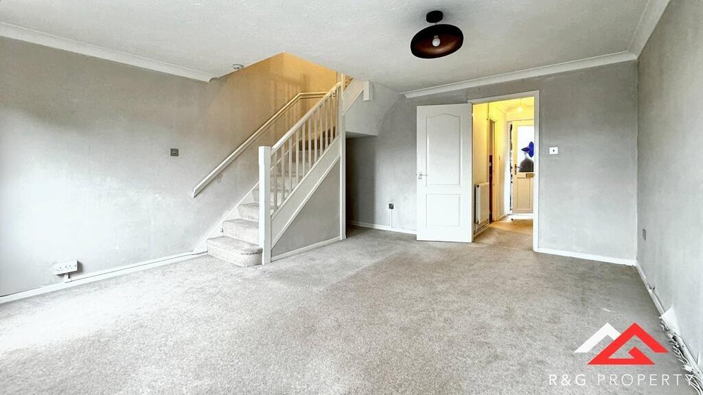 Spacious and well-maintained living room with a...