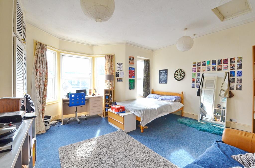Bright and spacious master bedroom featuring a ...