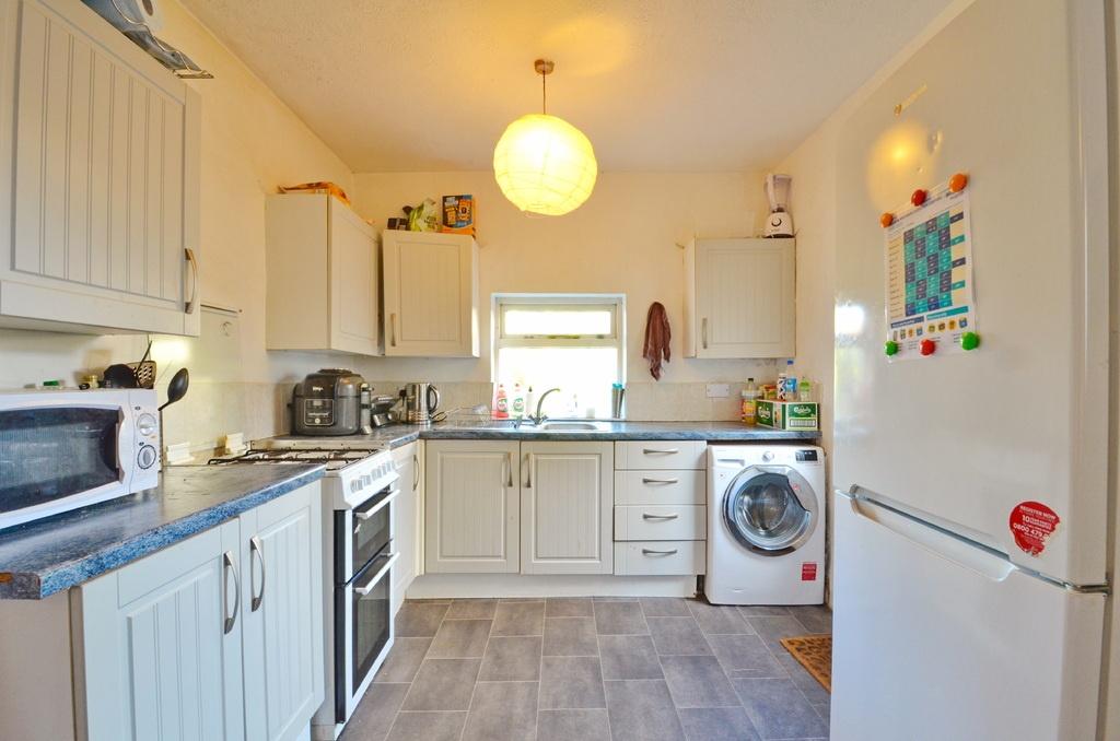 Bright and well-maintained kitchen with ample c...