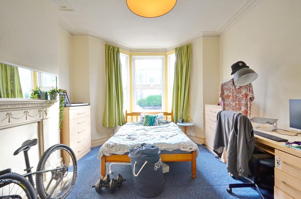 A bright and welcoming bedroom featuring a larg...