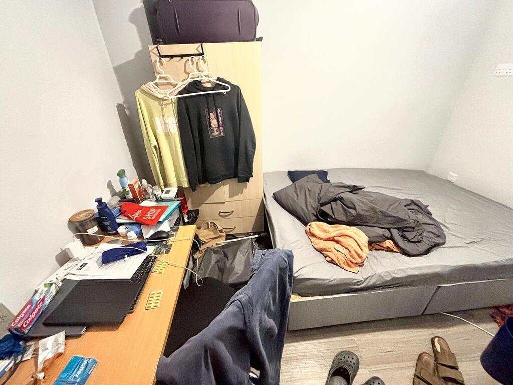 A straightforward bedroom with a neatly made be...