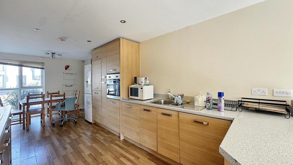 A modern and well-lit kitchen area featuring wo...