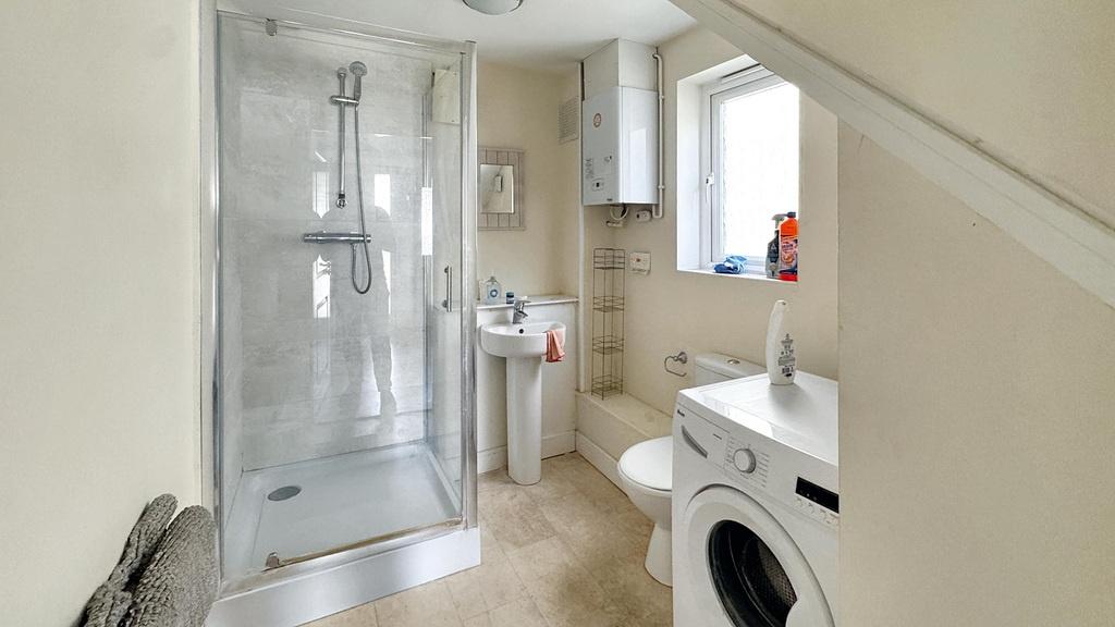 A clean and modern bathroom featuring a shower ...