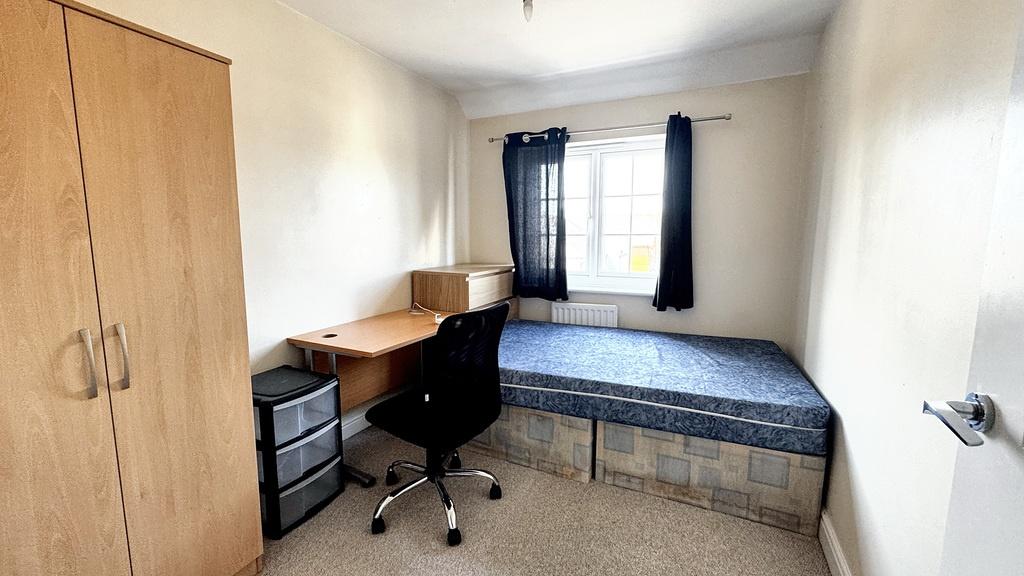 A straightforward single bedroom featuring a be...