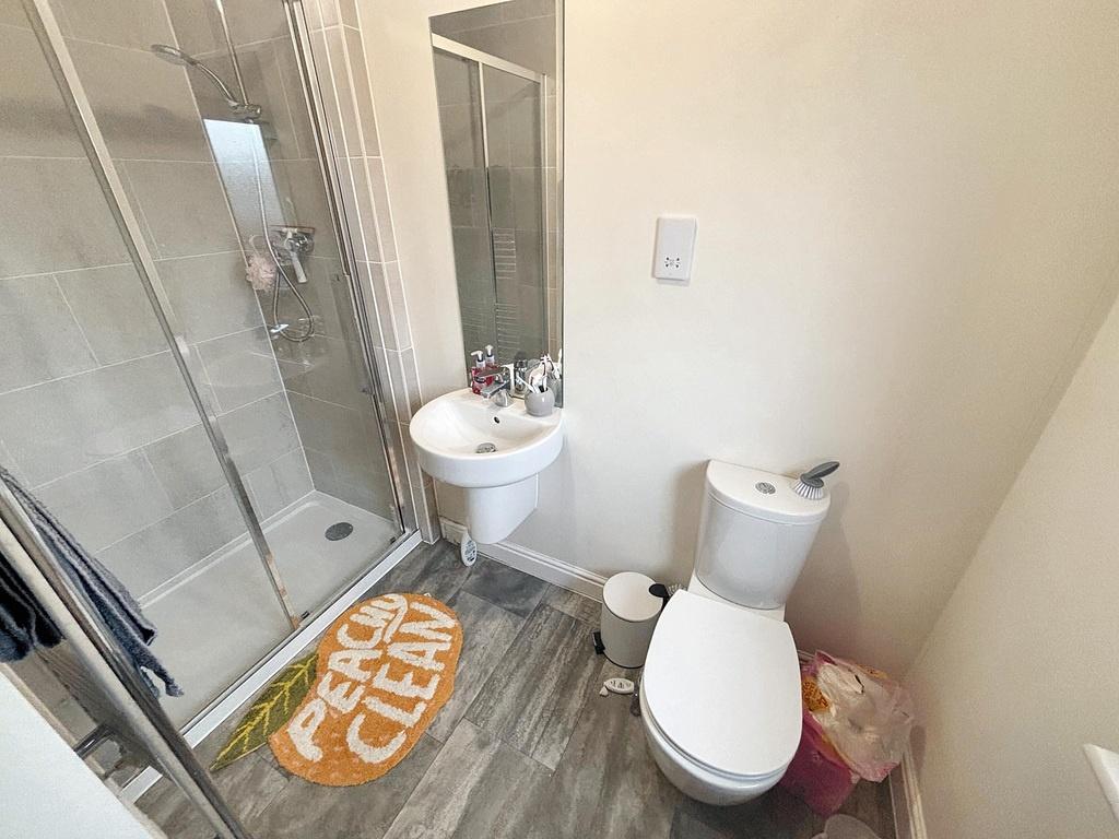 A clean and modern bathroom featuring a toilet,...