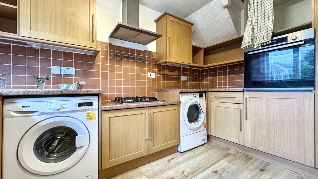 A clean and functional kitchen equipped with es...