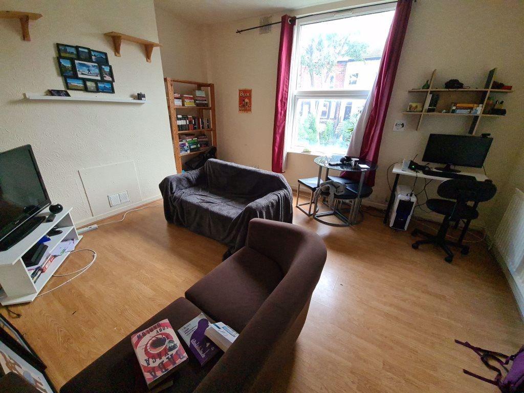 A cozy and well-maintained living room featurin...