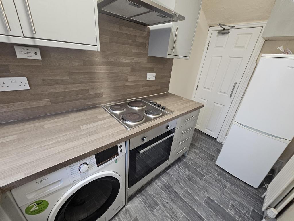 Compact modern kitchen with integrated applianc...