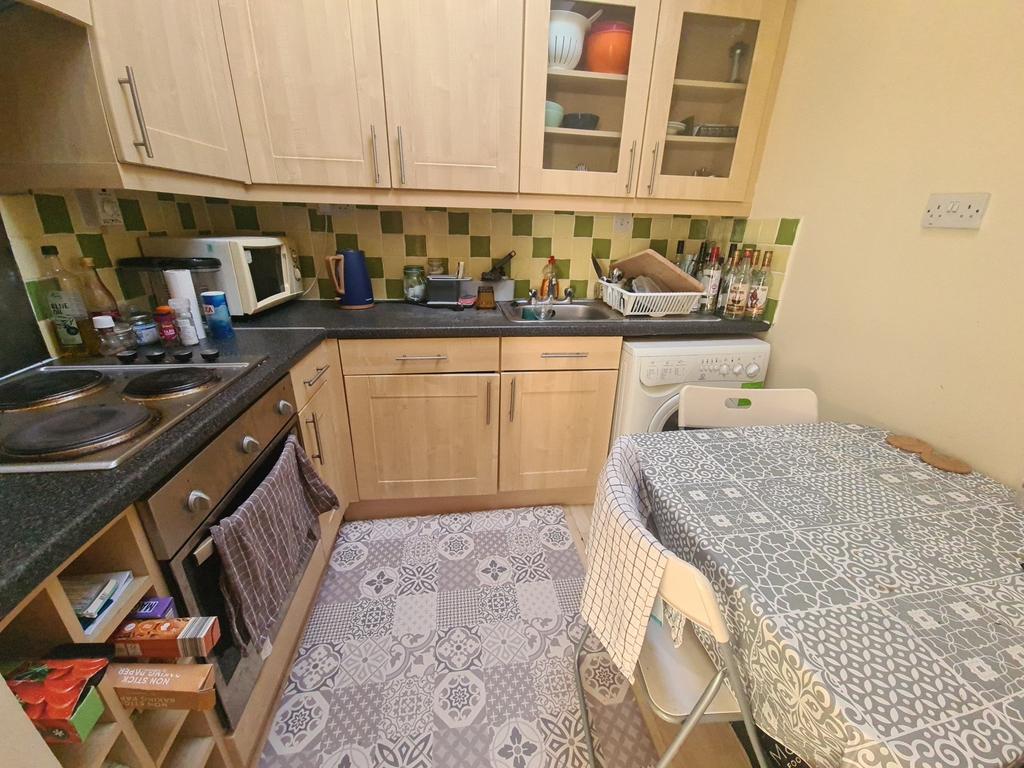 A cozy kitchen area featuring wooden cabinets a...