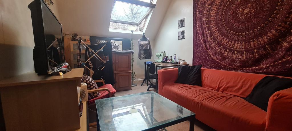 A cozy, well-lit living room featuring a comfor...