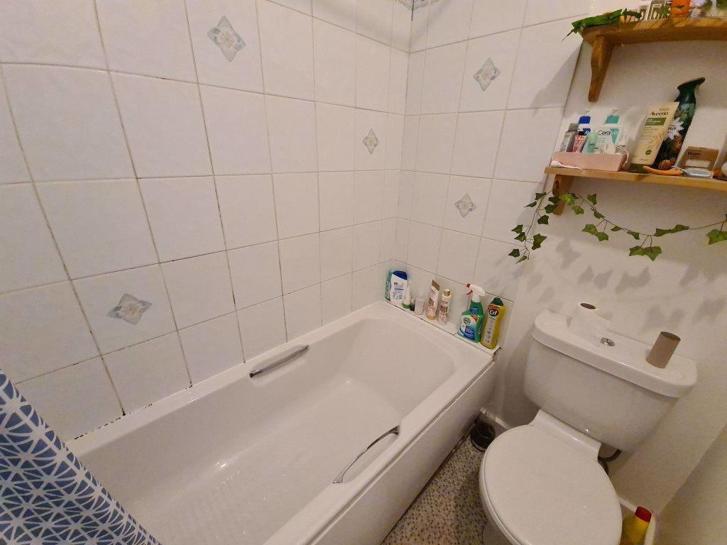A modern, clean bathroom with a large bathtub a...