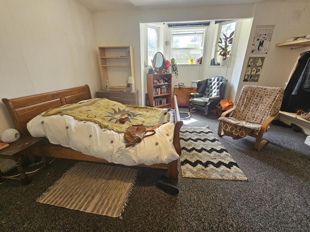 Spacious and inviting master bedroom featuring ...