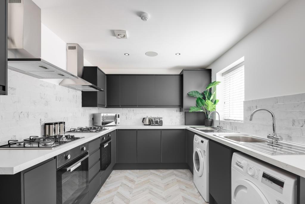 Modern and bright kitchen featuring sleek cabin...