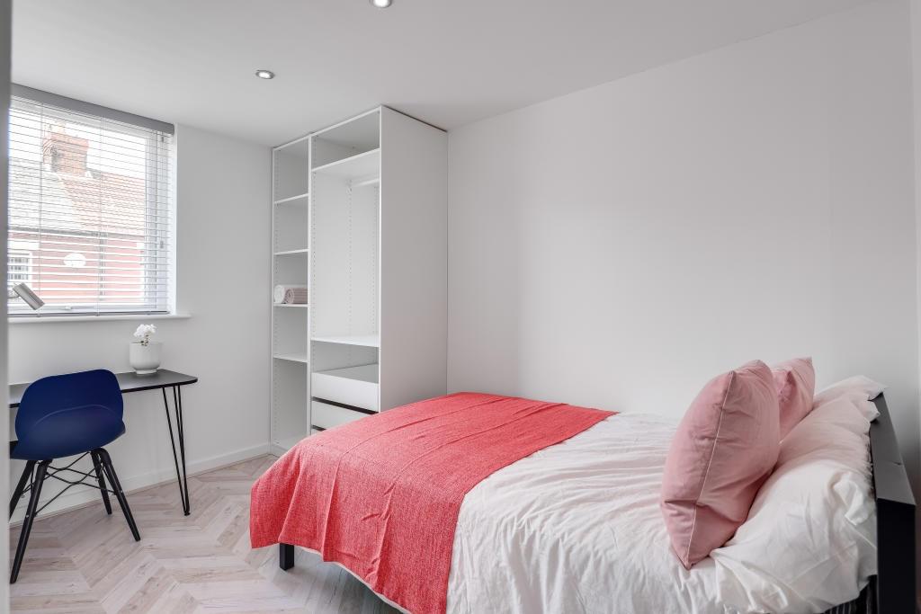 A cozy and neatly maintained bedroom featuring ...