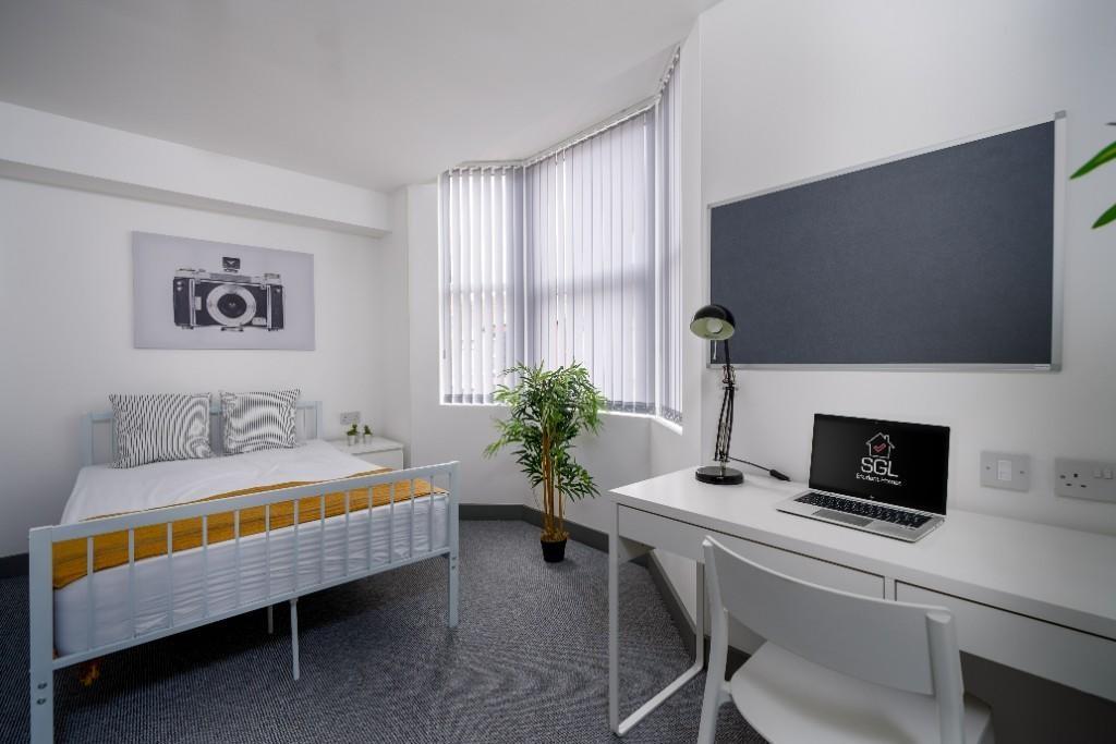 A bright and neatly maintained student bedroom ...