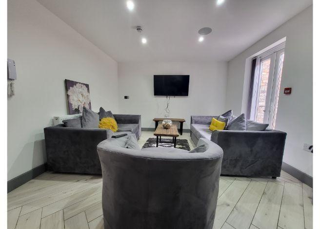 A spacious and modern living room featuring two...